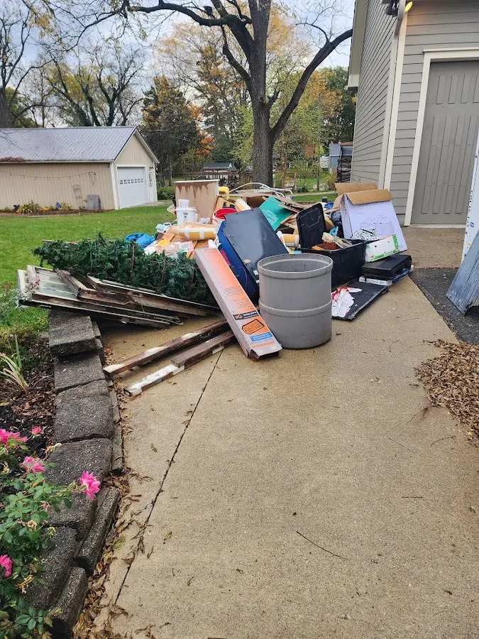 Dumpster being loaded with debris for Estate Cleanout Dumpster Rental in Pullman